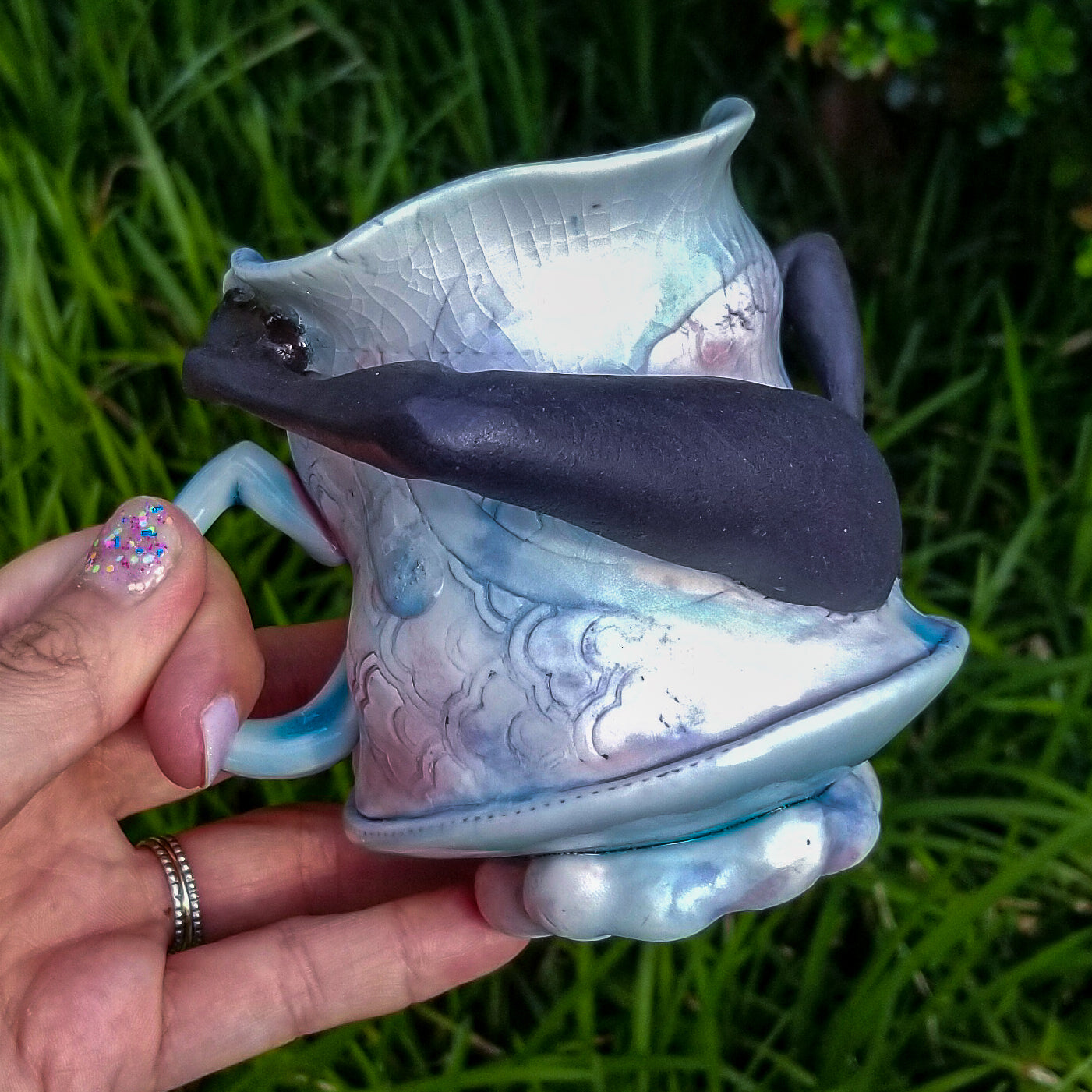 Handmade porcelain mug with figurative sculptural elements