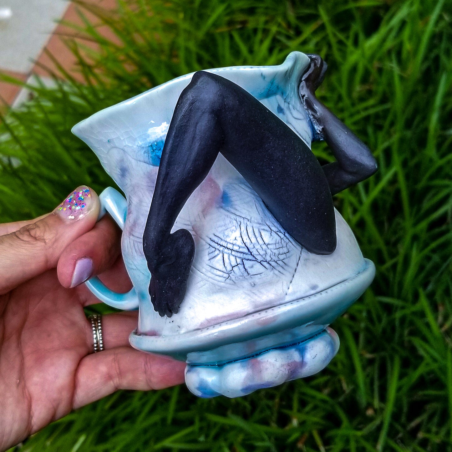 Handmade porcelain mug with figurative sculptural elements