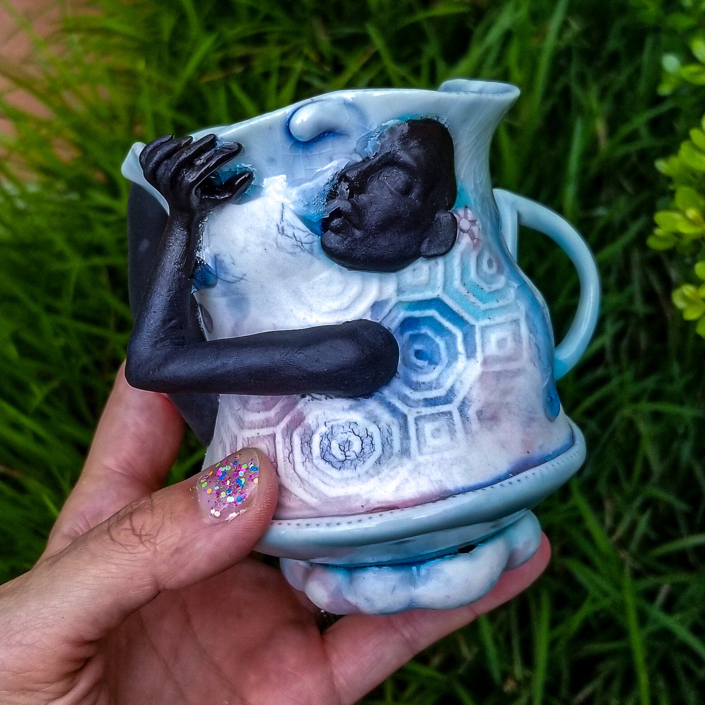 Handmade porcelain mug with figurative sculptural elements