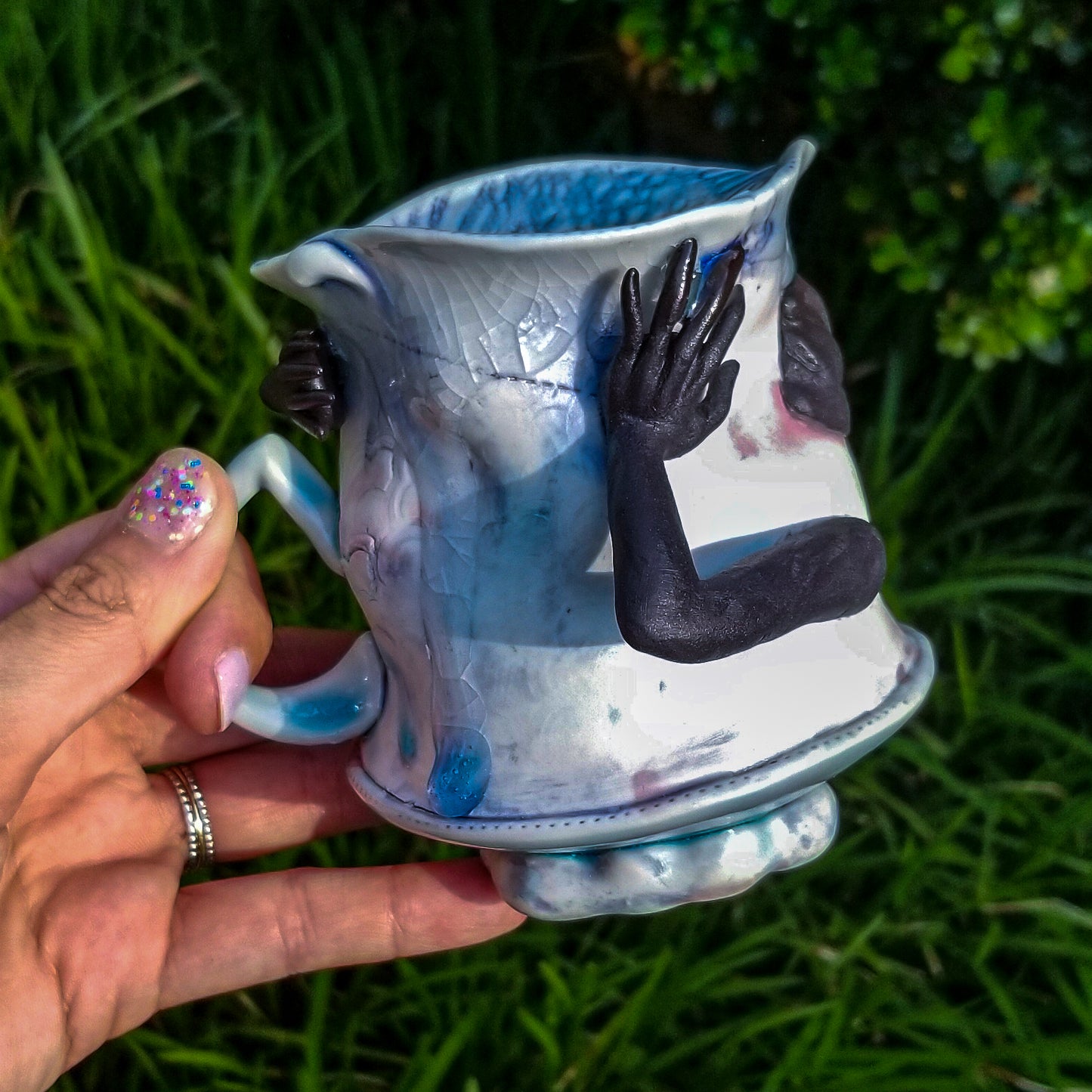 Handmade porcelain mug with figurative sculptural elements