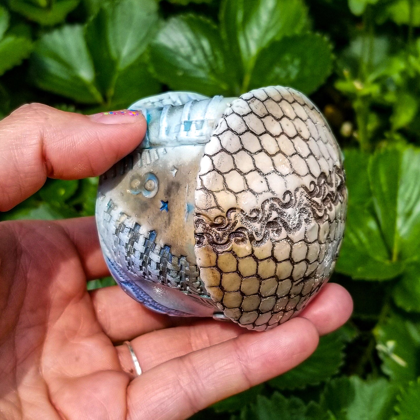 Bottom view of handmade stoneware ceramic soda fired cup blue color with pressed textures