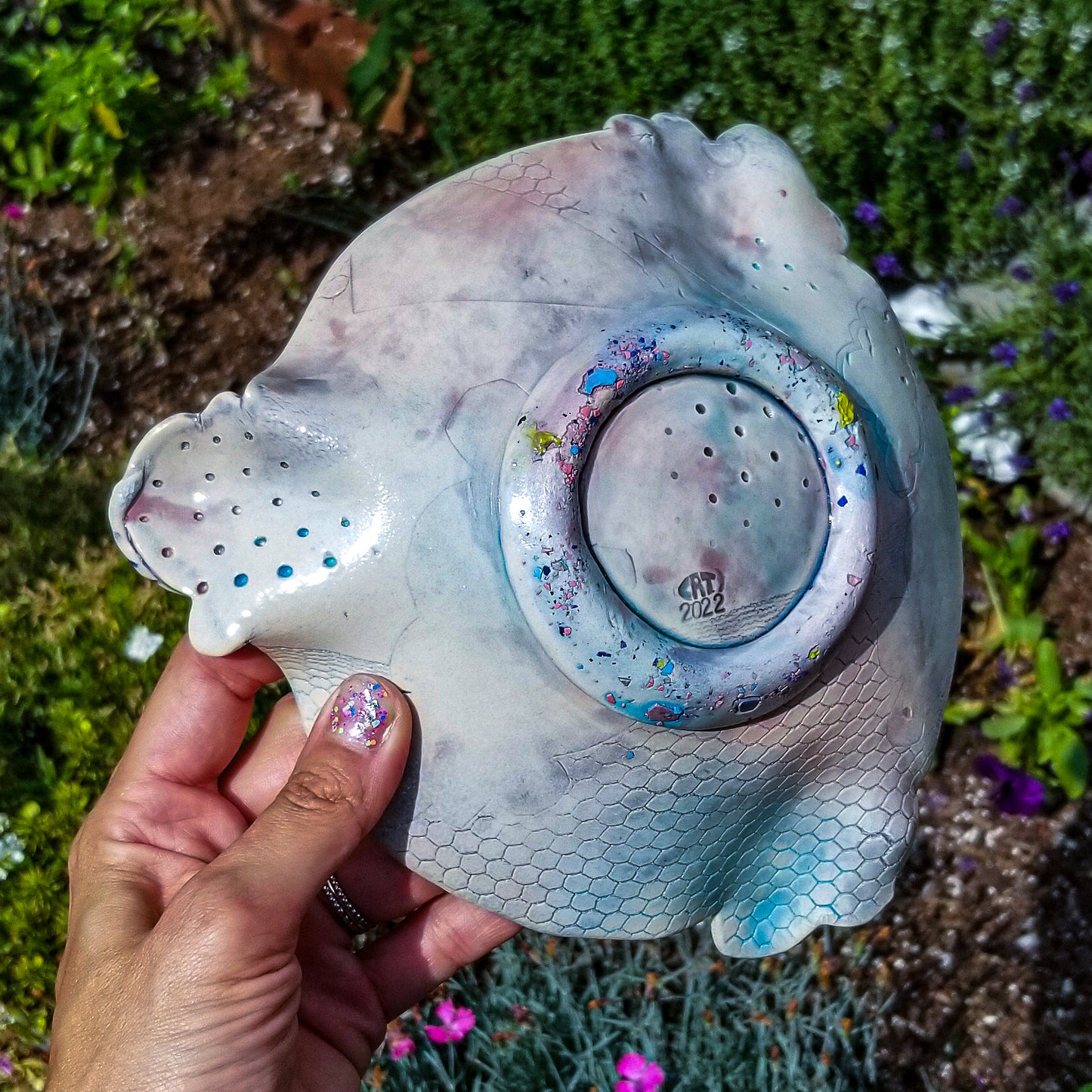 Bottom detail of handmade ceramic soda fired dish multi color with pressed textures