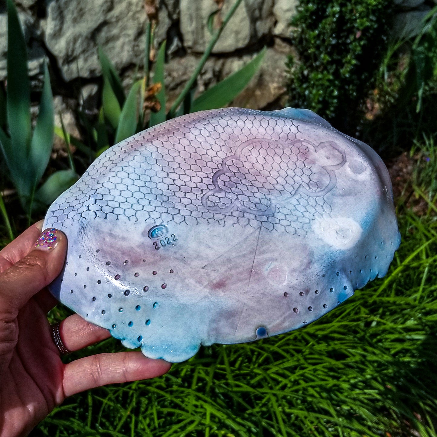Bottom detail of handmade porcelain ceramic soda fired oval tray dish multi color with pressed textures