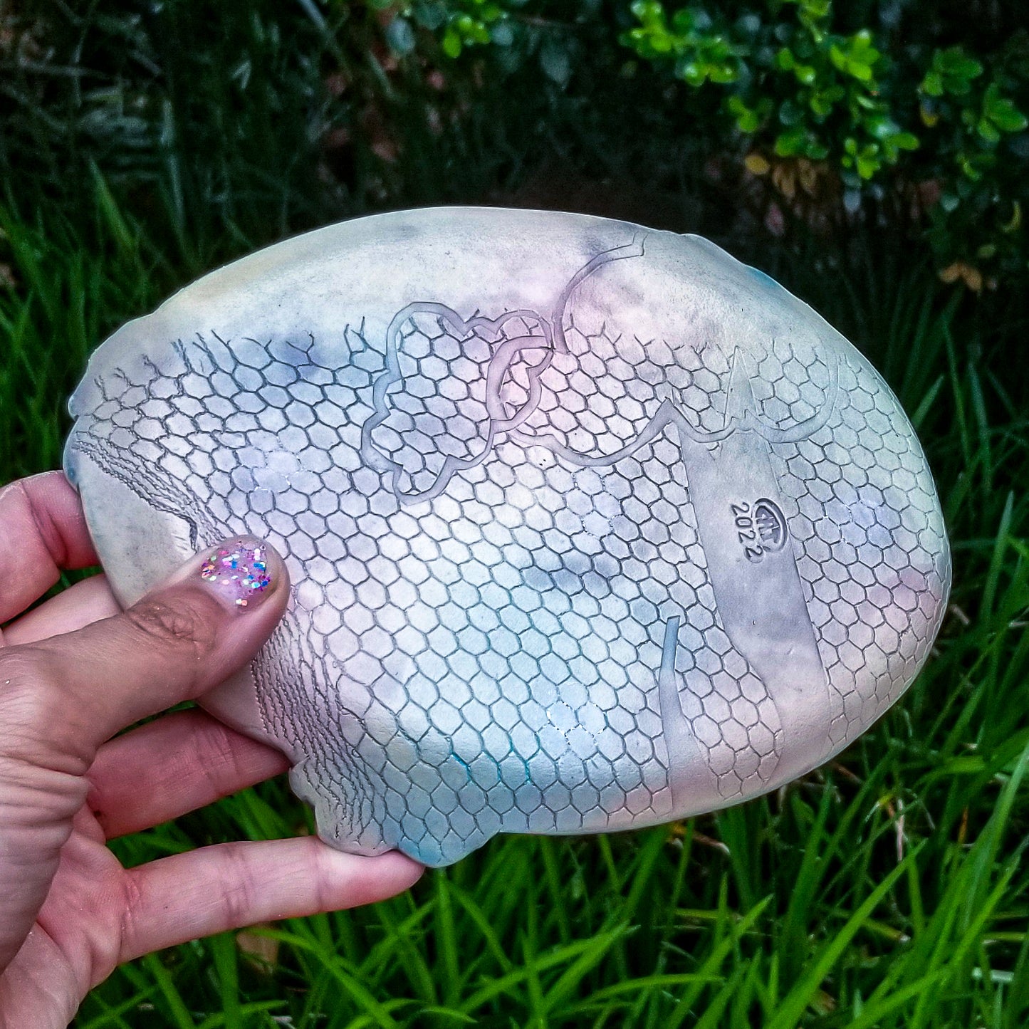 Bottom detail of handmade porcelain ceramic soda fired oval tray dish multi color with pressed textures
