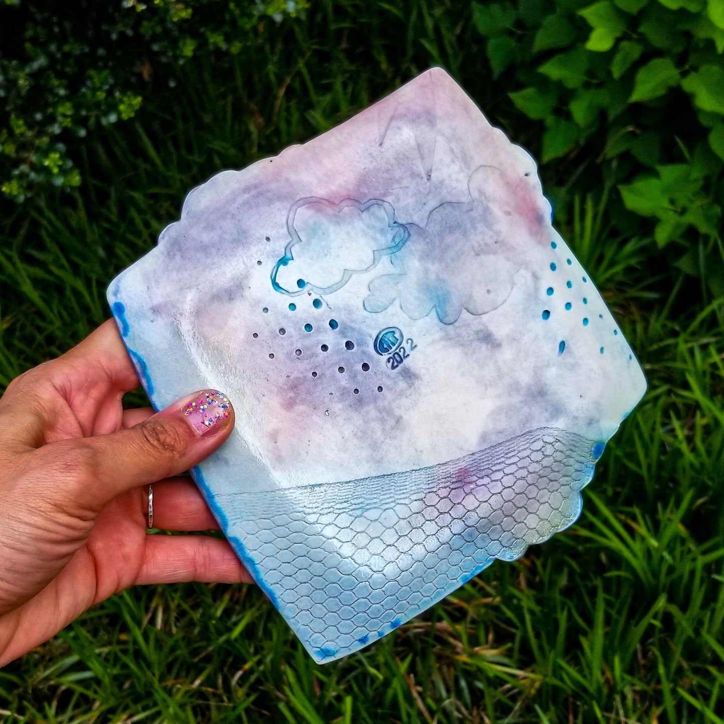 Bottom detail of handmade porcelain ceramic soda fired dish multi color with pressed textures