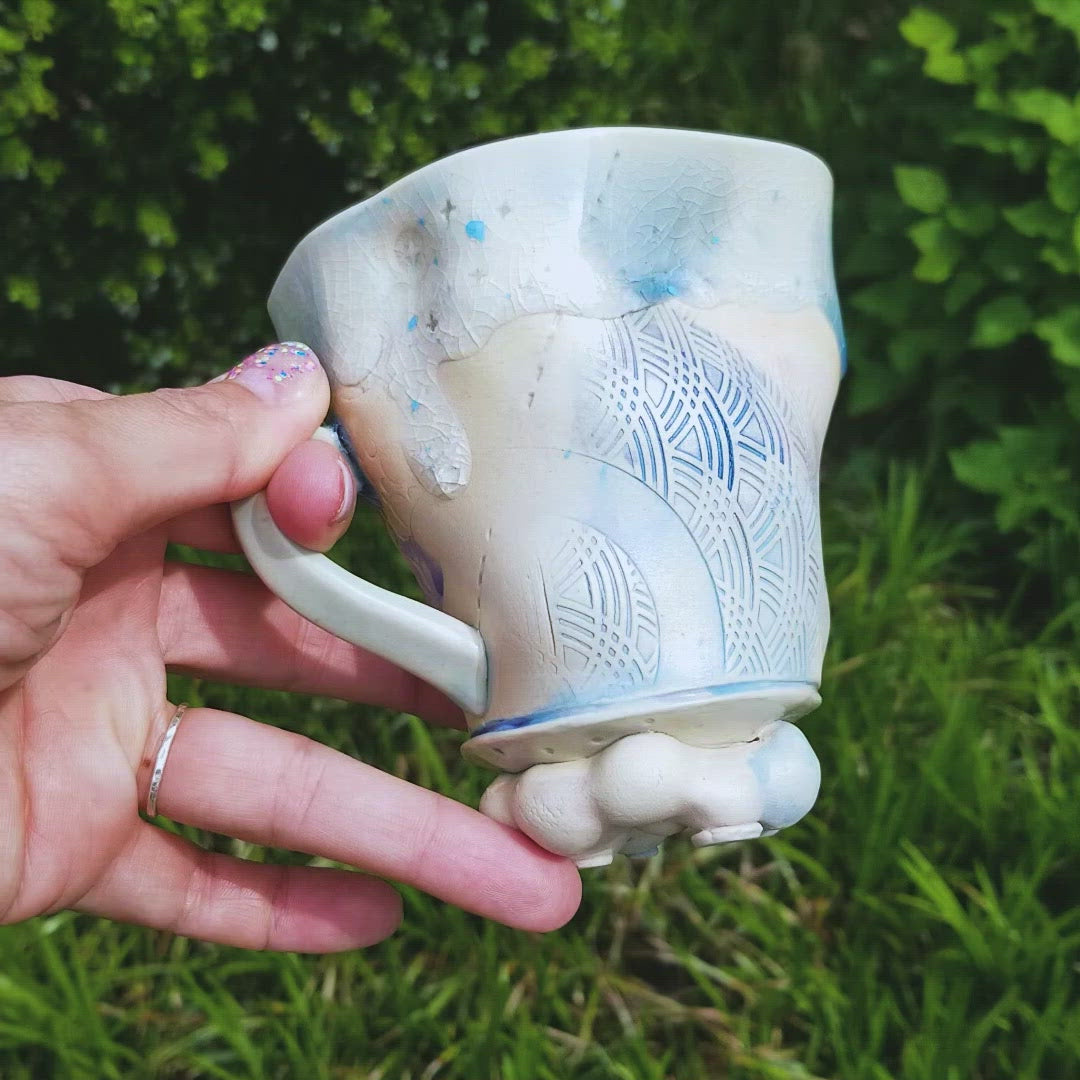 Video of handmade stoneware ceramic mug blue color with pressed textures