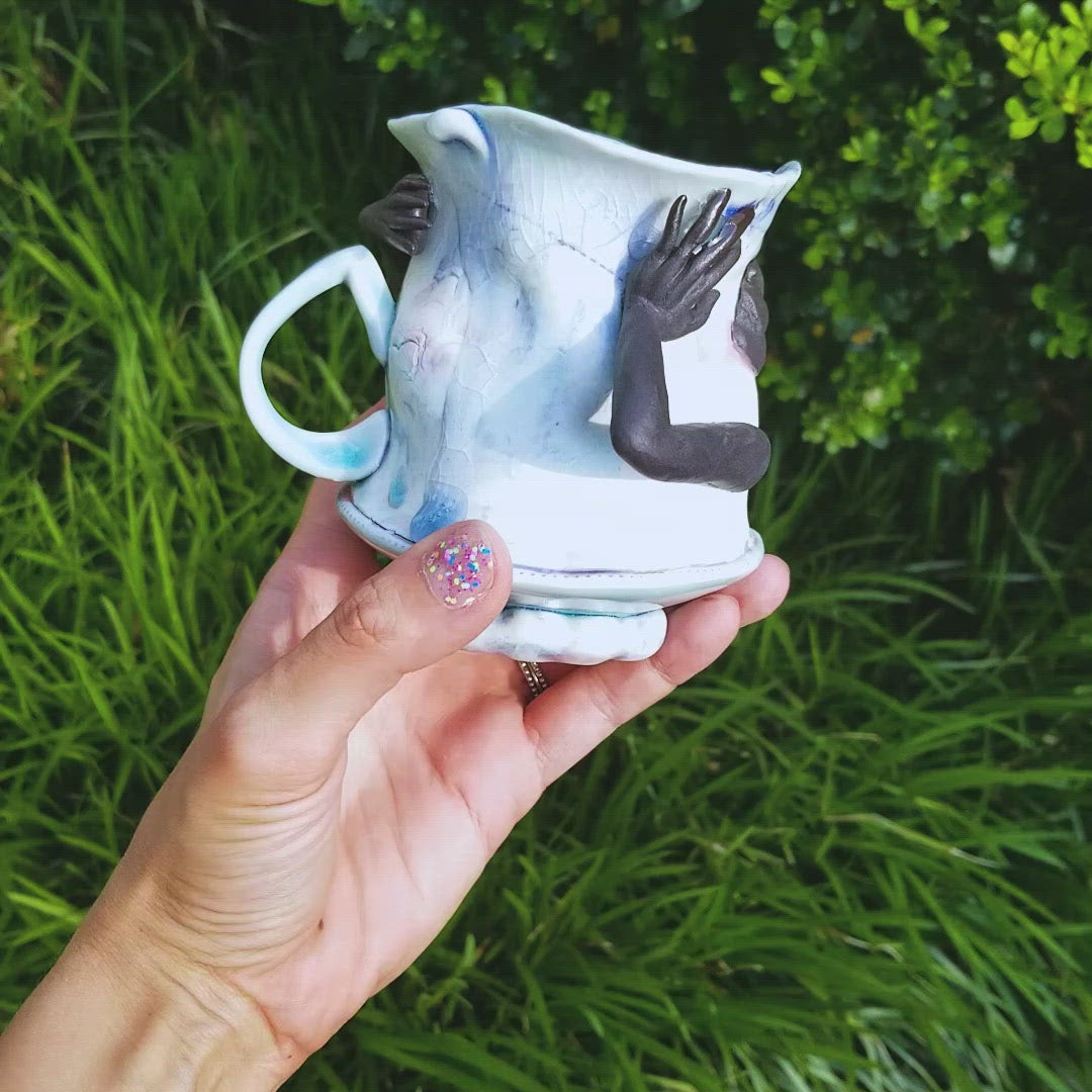 Video of handmade porcelain mug with figurative sculptural elements