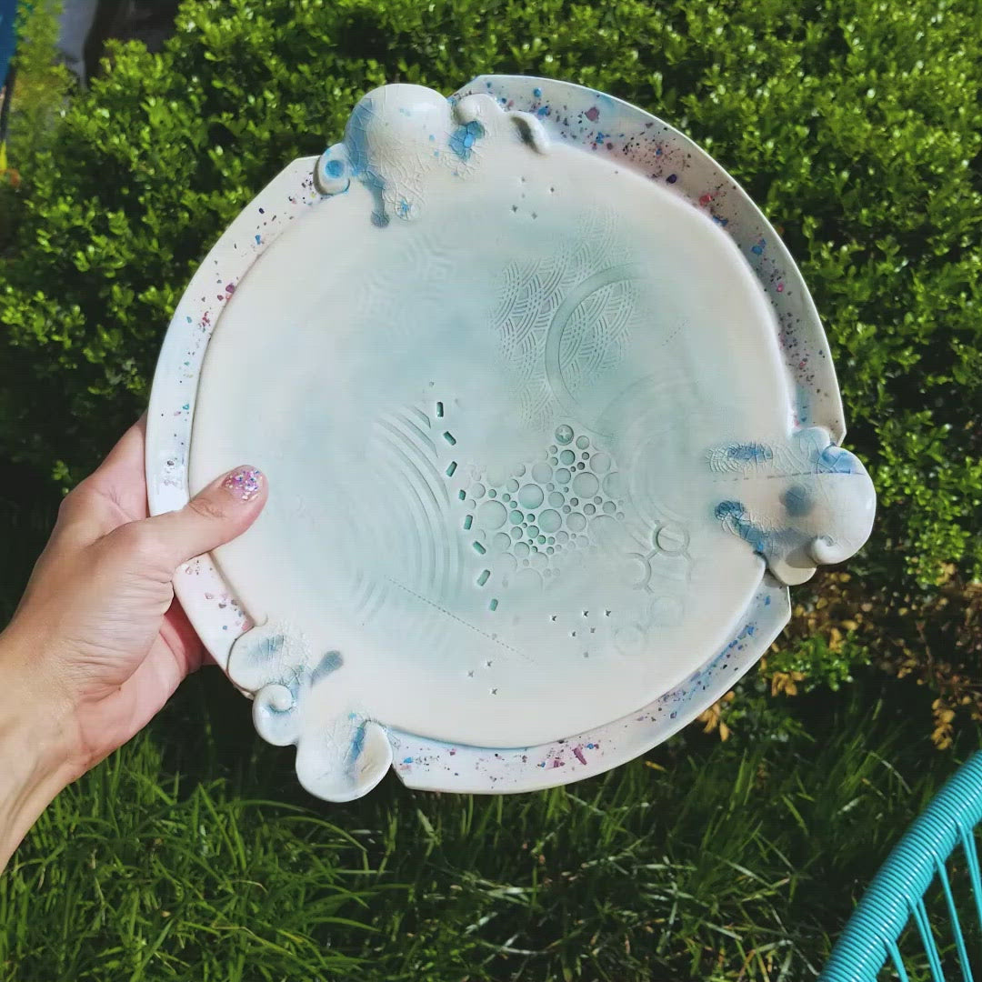 Video of handmade ceramic soda fired platter multi color with pressed textures