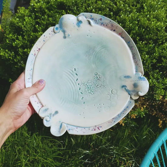 Video of handmade ceramic soda fired platter multi color with pressed textures