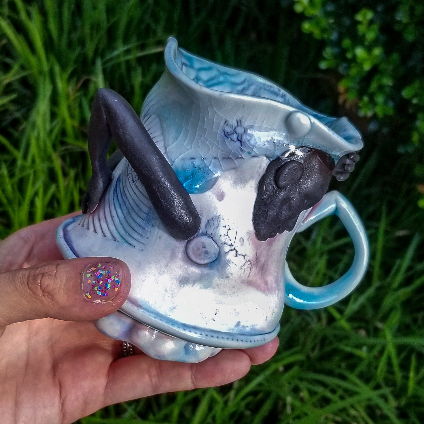 Handmade porcelain mug with figurative sculptural elements