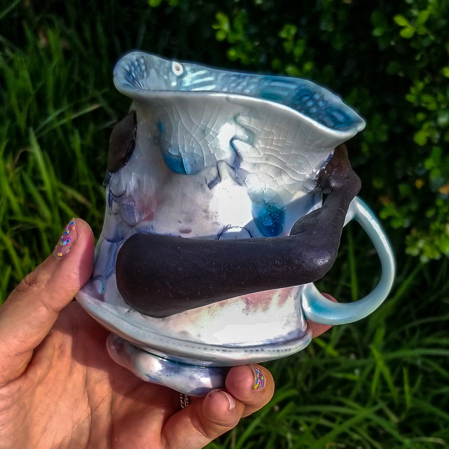 Handmade porcelain mug with figurative sculptural elements