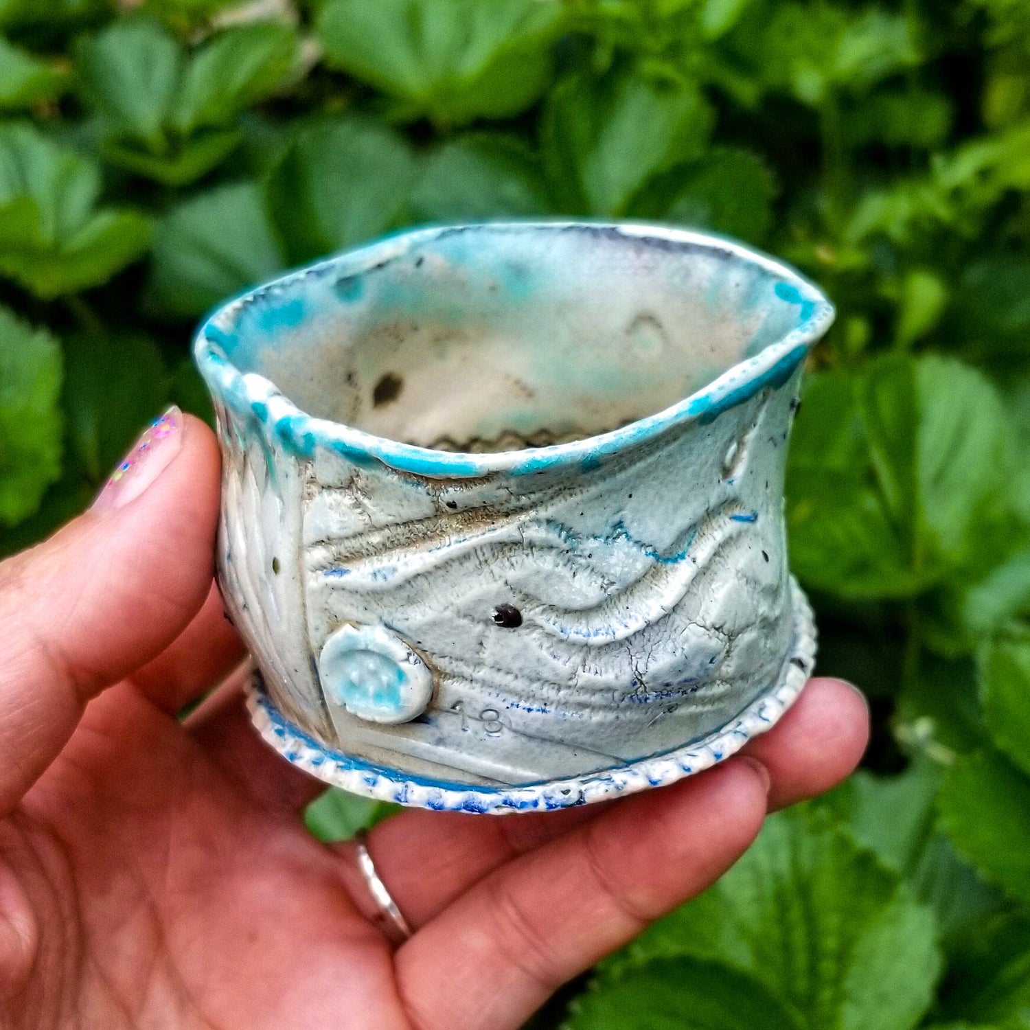 Handmade stoneware ceramic soda fired cup blue color with pressed textures