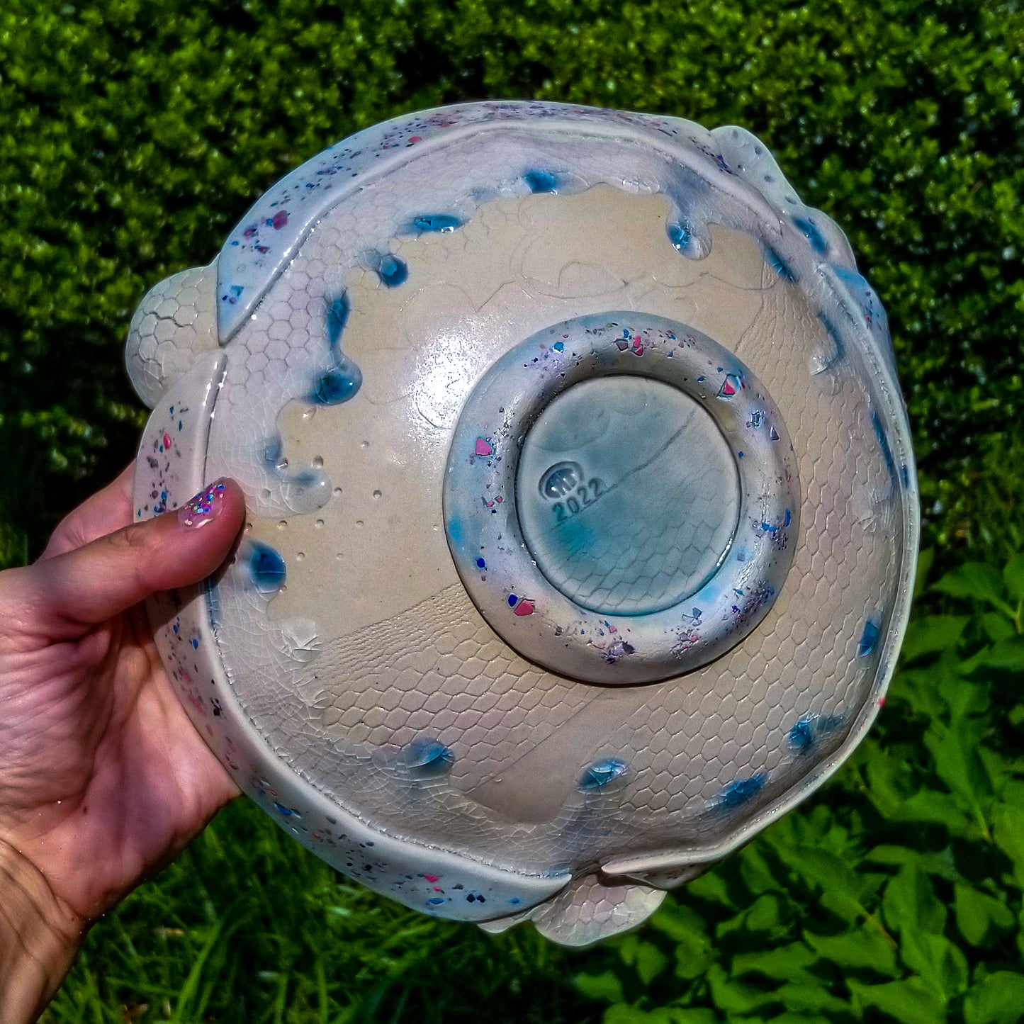 Bottom detail of handmade ceramic soda fired serving bowl multi color with pressed textures