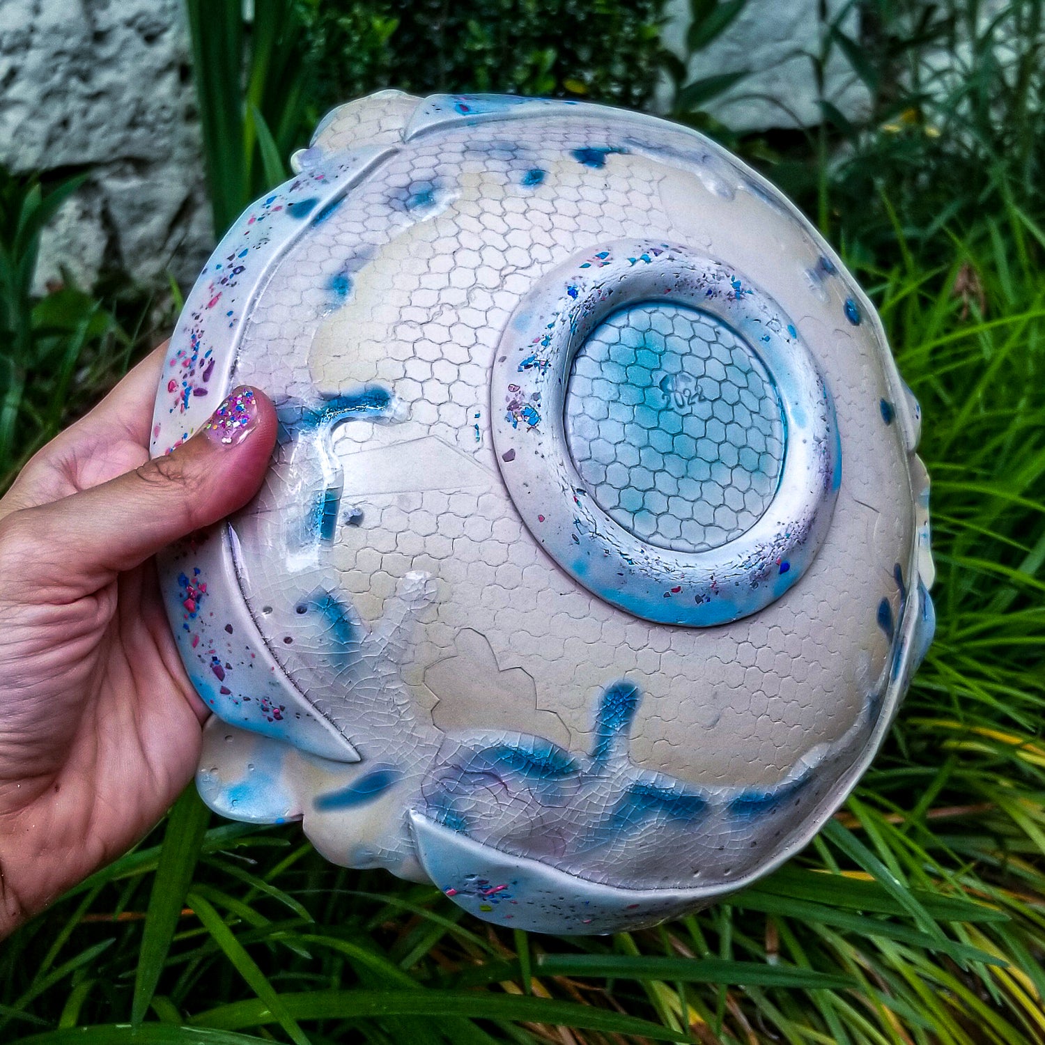 Bottom detail of handmade ceramic soda fired serving bowl multi color with pressed textures