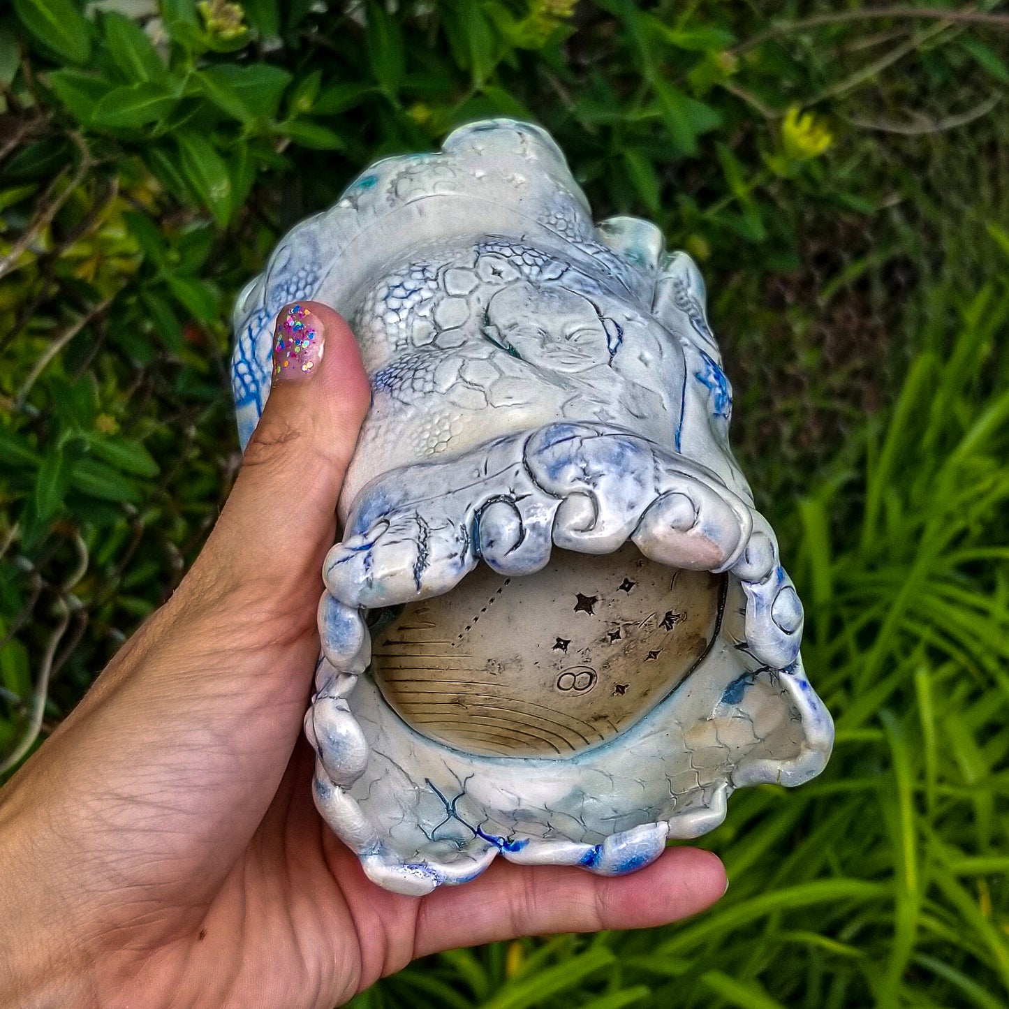 Bottom detail of handmade stoneware ceramic soda fired vase multi color with pressed textures