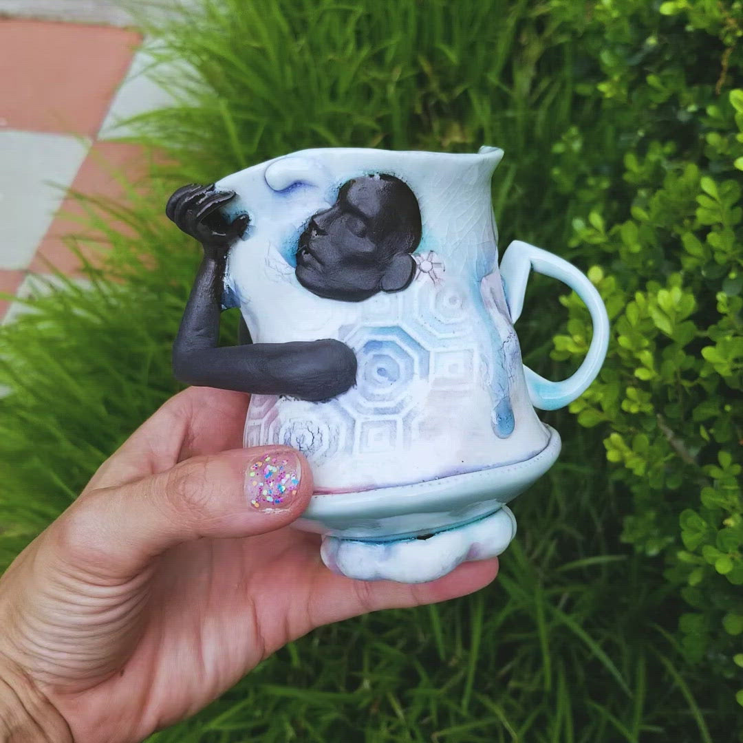 Video of handmade porcelain mug with figurative sculptural elements