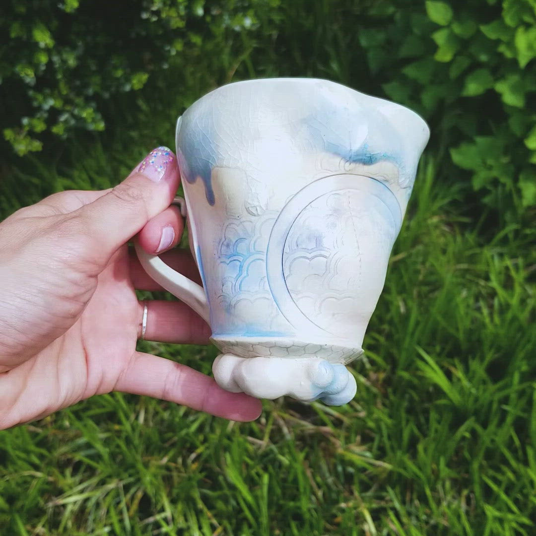 Video of handmade stoneware ceramic mug blue color with pressed textures