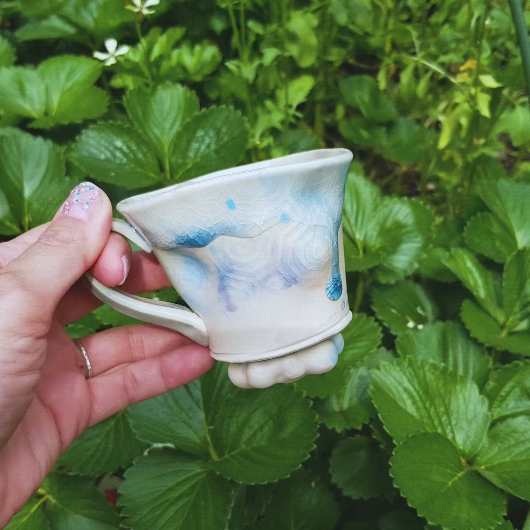 Video of handmade stoneware ceramic mug blue color with pressed textures