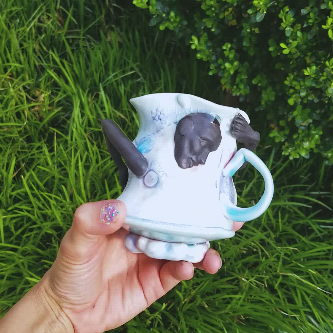 Video of handmade porcelain mug with figurative sculptural elements